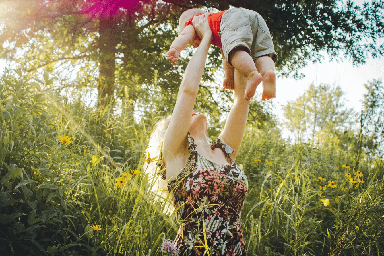 Spring time, bright sunlight, holding up baby