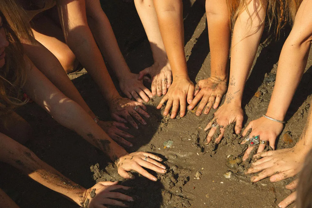 Womens hands in the mud
